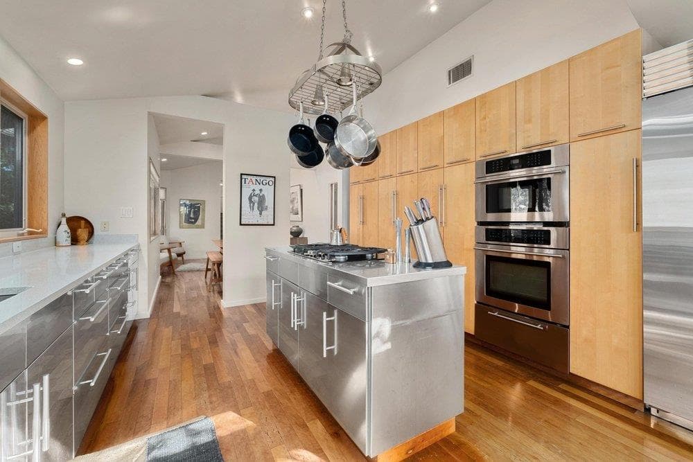Kitchen featuring modern cabinets, lofted ceiling