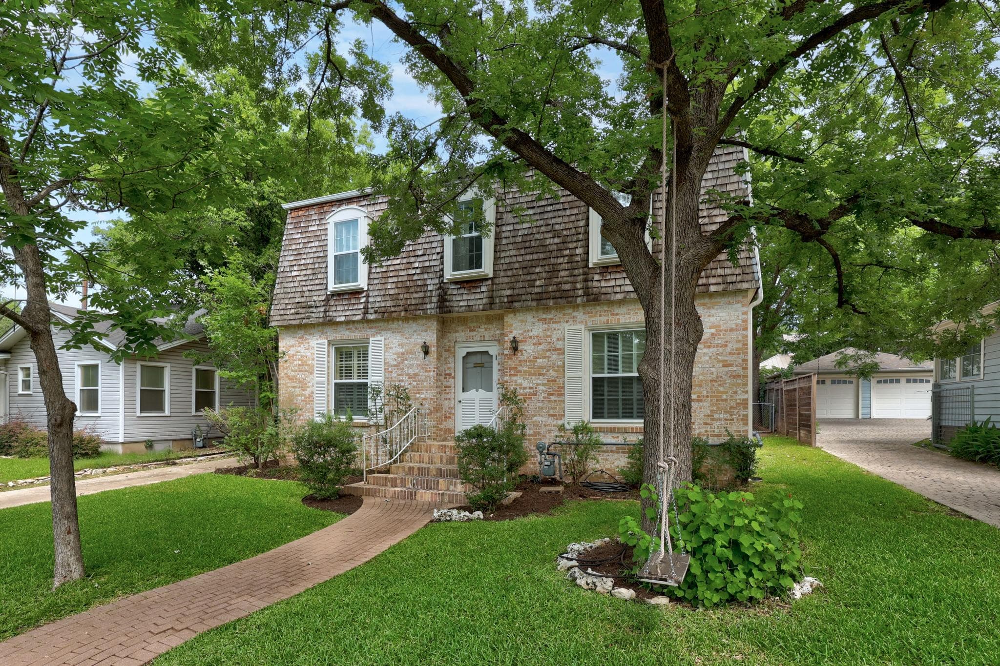 A charming brick exterior with wood shake mansard