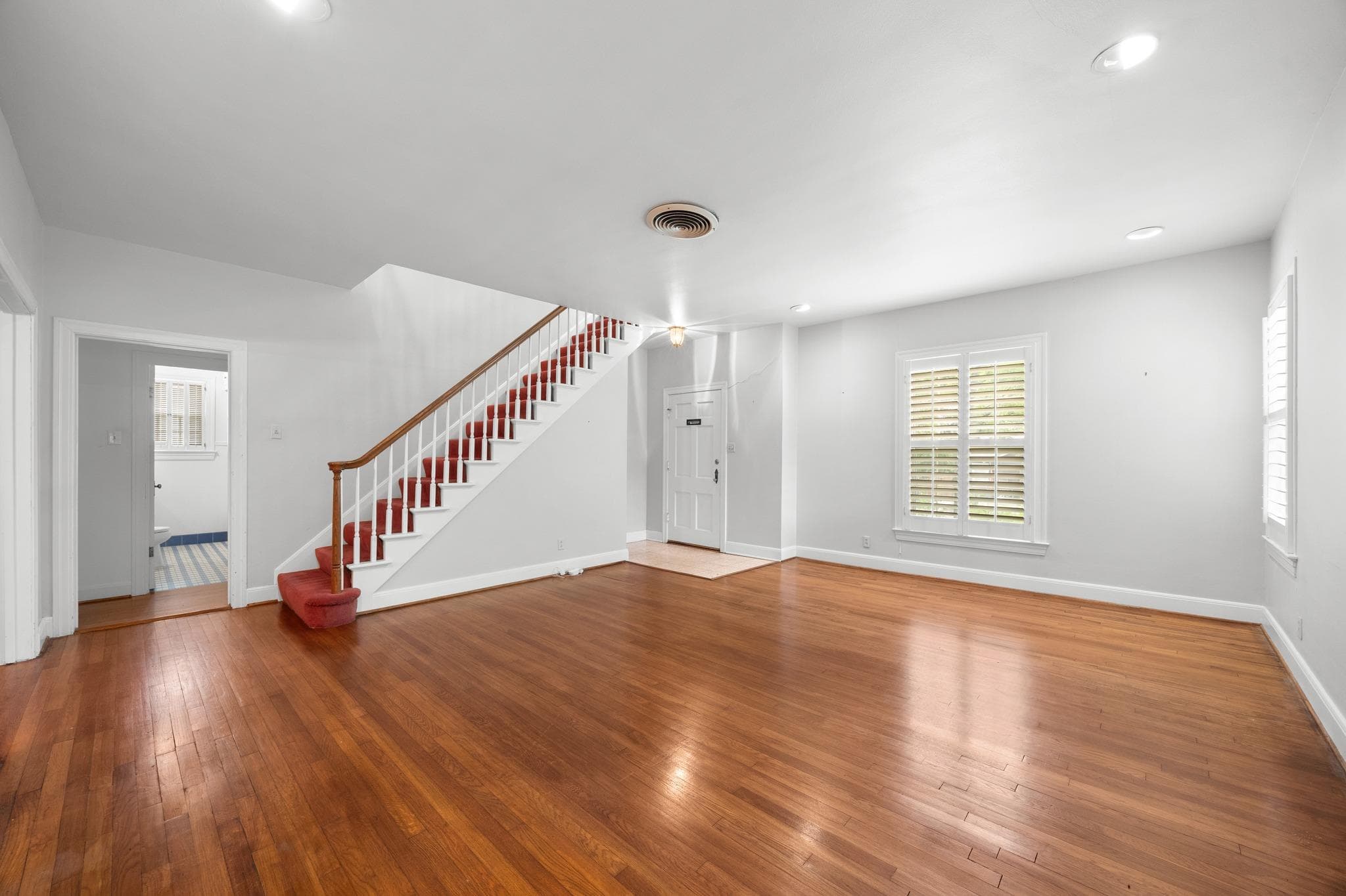 Rich hardwood floors welcome you into this genero