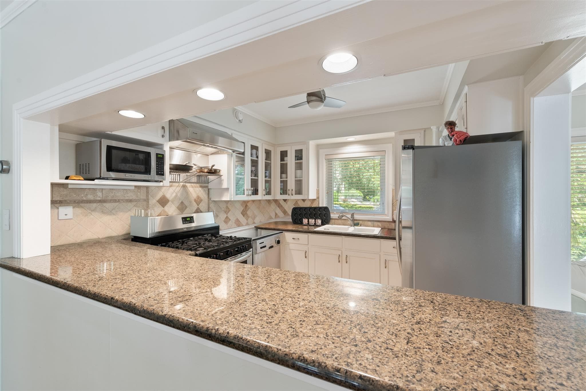 A well-appointed kitchen features polished granit