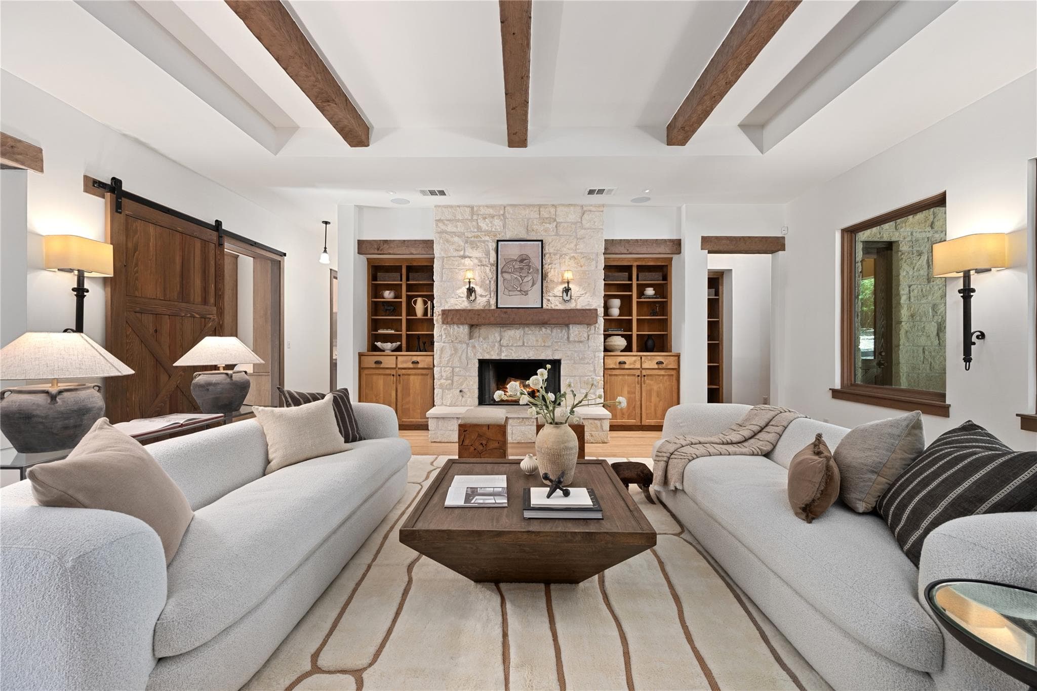 Exposed wood beams adorn the high ceilings of thi
