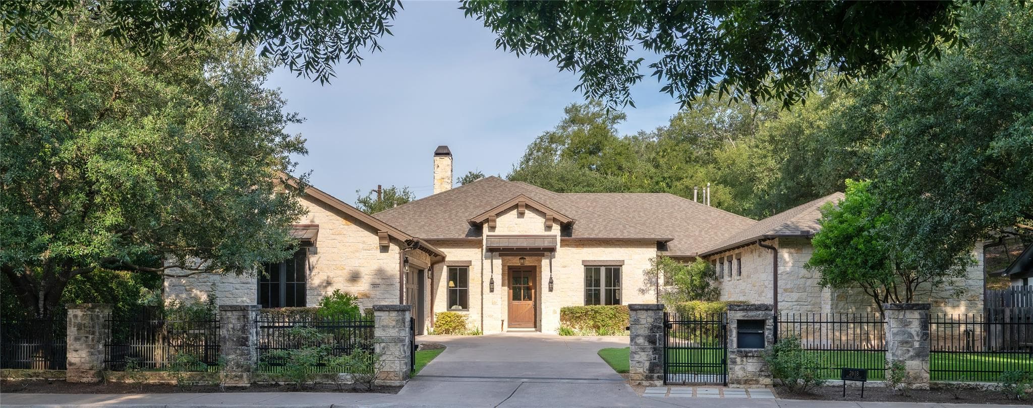A graceful stone residence with a private drivewa