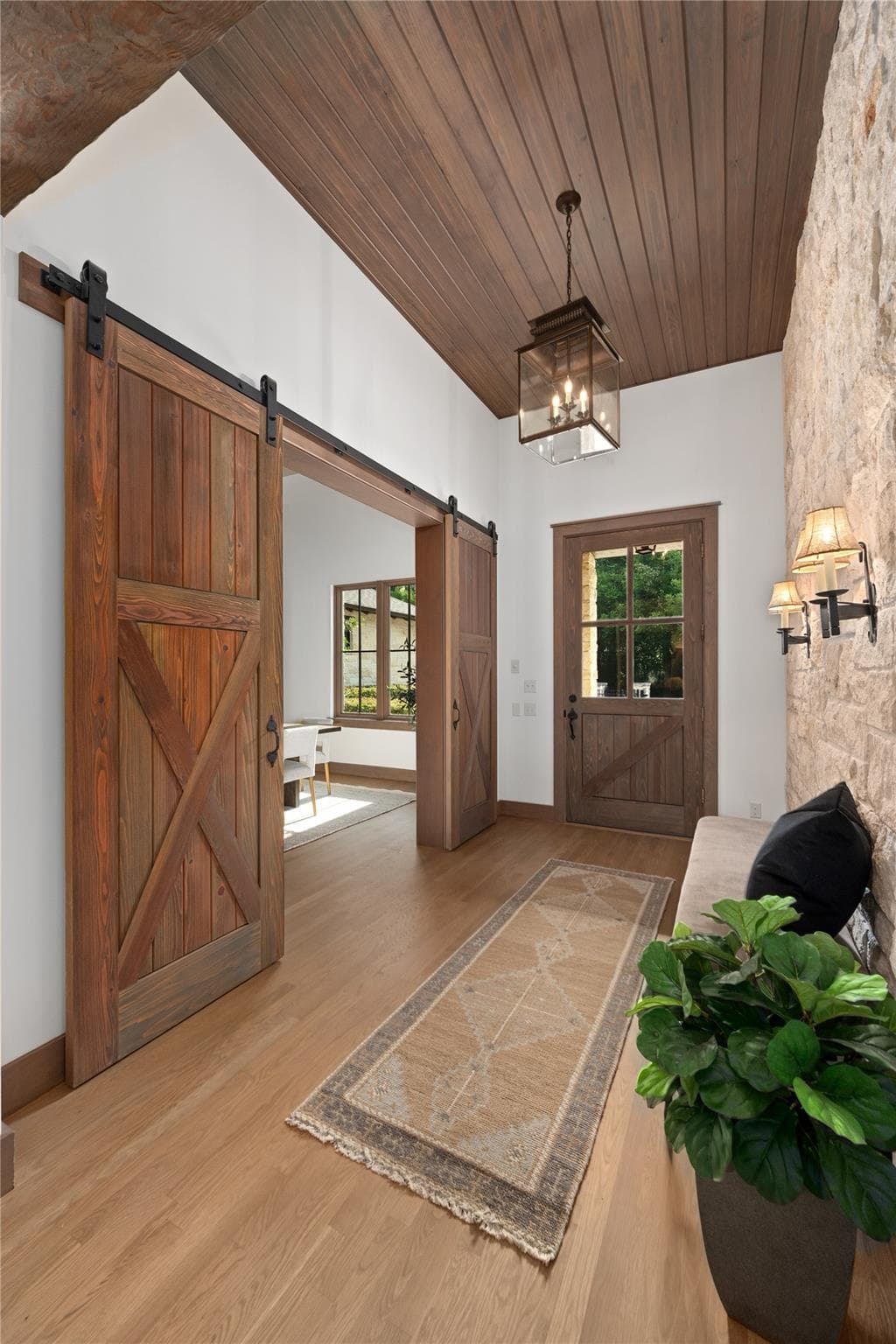A welcoming entryway with natural wood flooring,