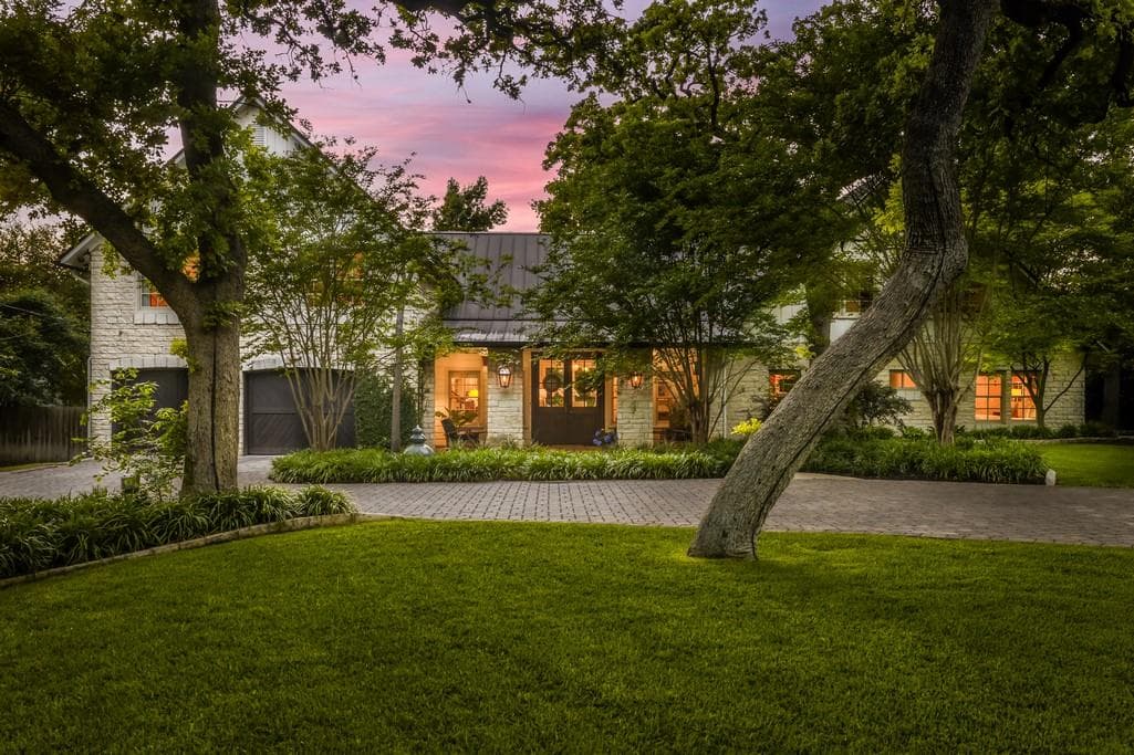 Stone facade residence featuring a covered entry,