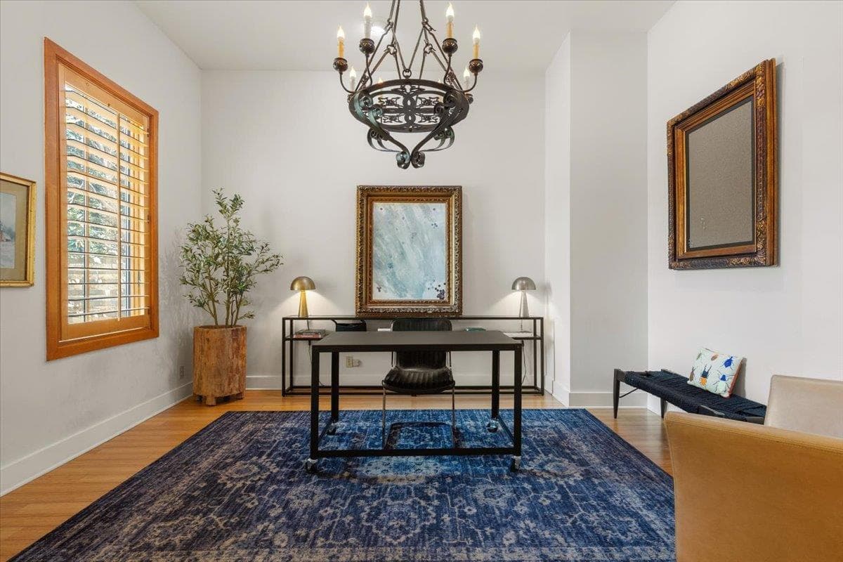 Office area with a chandelier and wood finished f