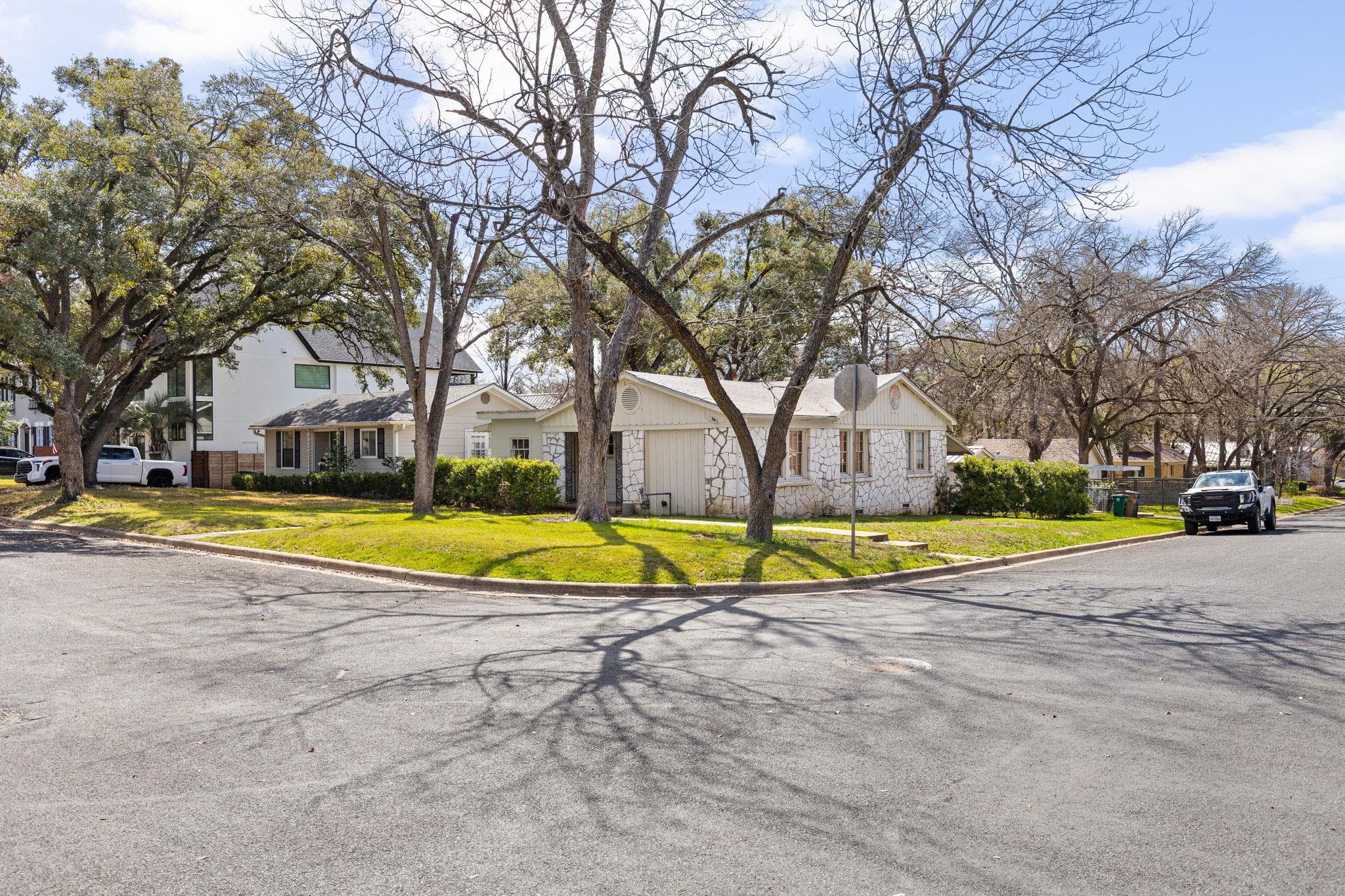 Corner lot featuring a stone exterior residence,