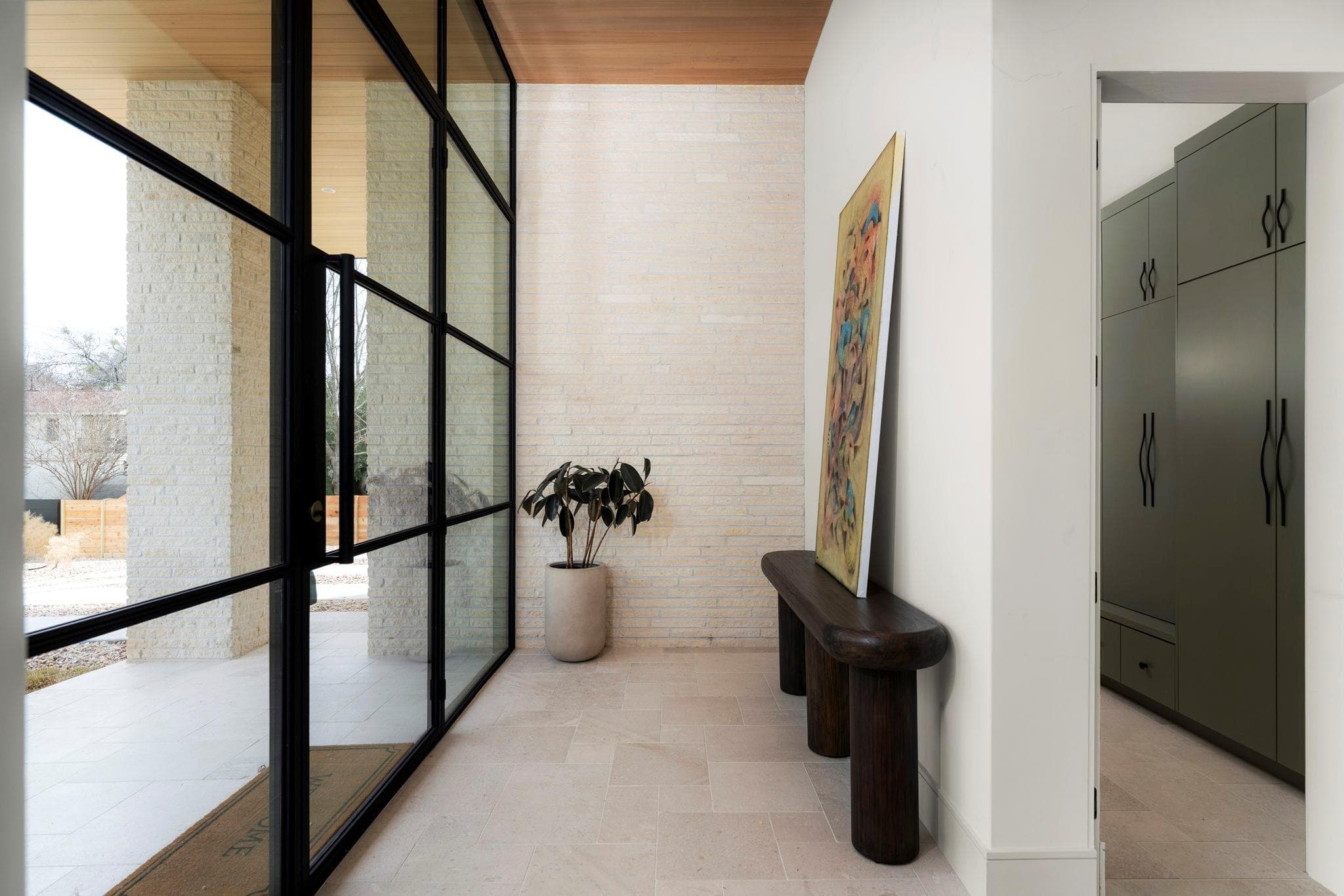 Modern entryway featuring black-framed glass pane